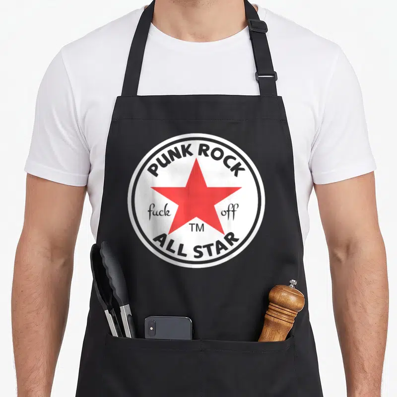 Tablier de cuisine noir avec logo circulaire blanc, étoile rouge centrale et texte Punk Rock All Star en gris.