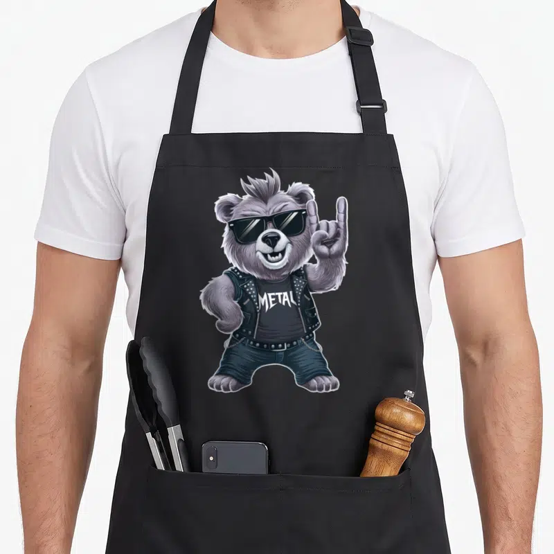 Tablier de cuisine noir avec illustration d'un ours brun rocker portant des lunettes noires et un gilet clouté.