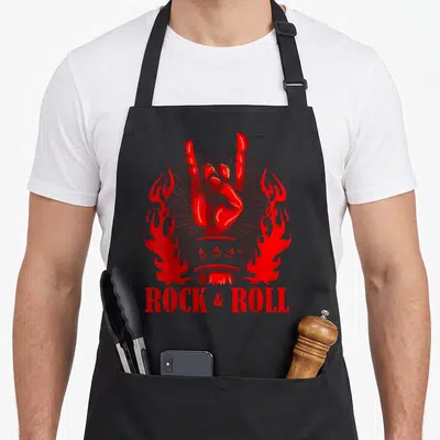Tablier de cuisine noir avec une main rouge formant le signe des cornes, des flammes et l'inscription ROCK & ROLL.