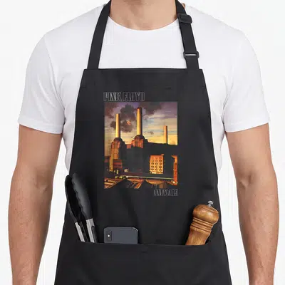 Tablier de cuisine noir avec illustration des cheminées de l'usine Animals et texte Pink Floyd Animals.