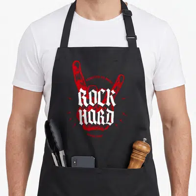 Tablier de cuisine noir avec une main rouge stylisée et le texte blanc Rock Hard au centre.