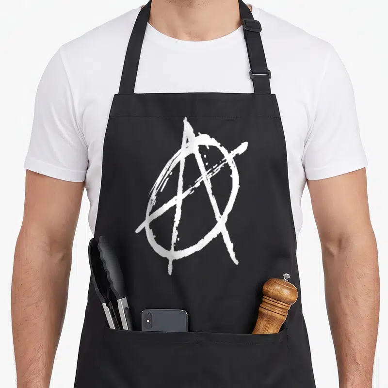Tablier de cuisine noir avec un grand A entouré d'un cercle en style graffiti blanc au centre.