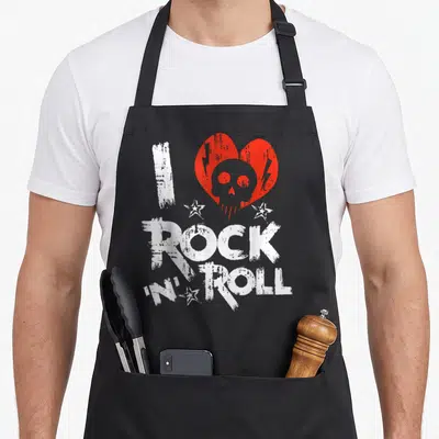 Tablier de cuisine noir avec inscription rock and roll, cœur rouge, crâne gris et étoiles blanches au style brushé.