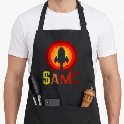 Tablier de cuisine noir avec illustration fusée AMC et texte stonk coloré sur fond uni.