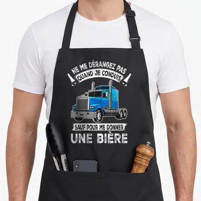 Tablier de cuisine noir avec illustration de camionneur bleu et texte humoristique sur fond uni.