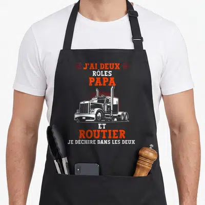 Tablier de cuisine noir avec illustration de camion routier et texte Papa et Routier en orange et blanc.