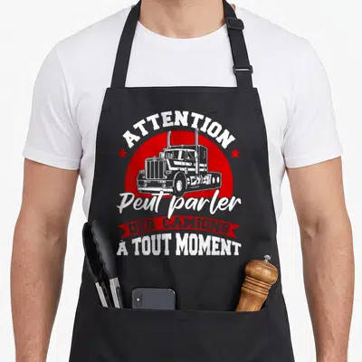 Tablier de cuisine noir avec illustration de camion et texte blanc sur cercle rouge.