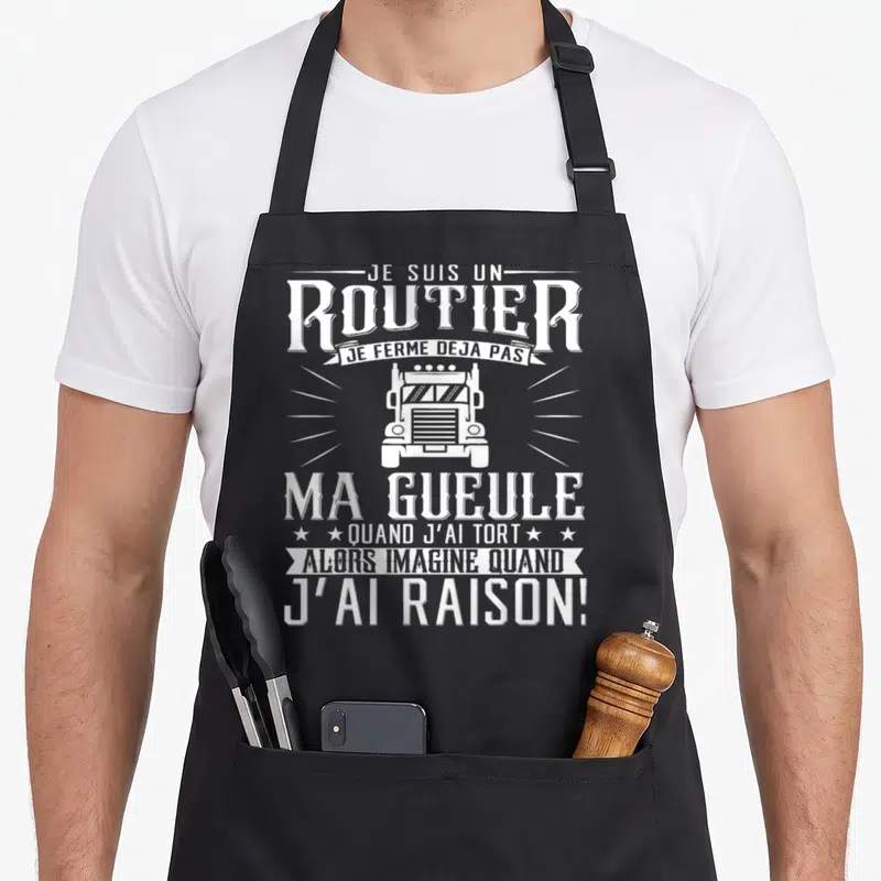 Tablier de cuisine noir avec illustration frontale de camion et texte blanc humoristique en typographie vintage.
