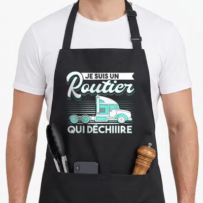 Tablier de cuisine noir avec illustration semi-remorque turquoise et texte Je suis un routier qui déchiire en blanc et bleu clair.