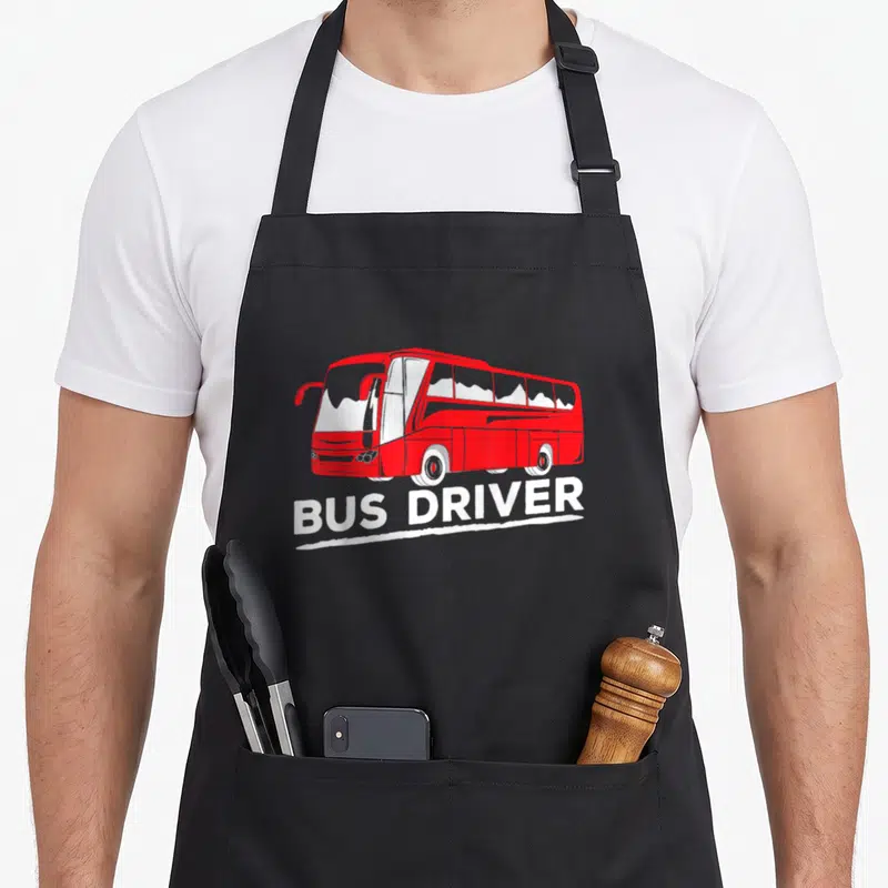 Tablier de cuisine noir avec illustration d'un bus rouge et inscription white BUS DRIVER en bas.