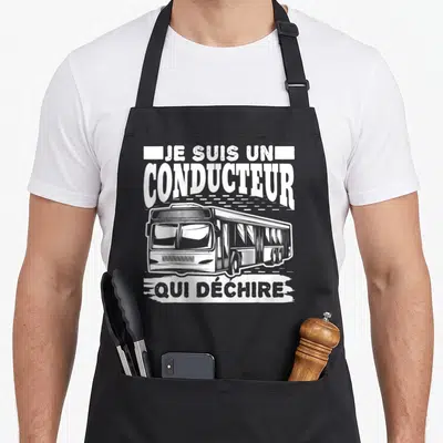 Tablier de cuisine noir avec illustration de bus blanc et texte Je suis un conducteur qui déchire imprimé au centre.