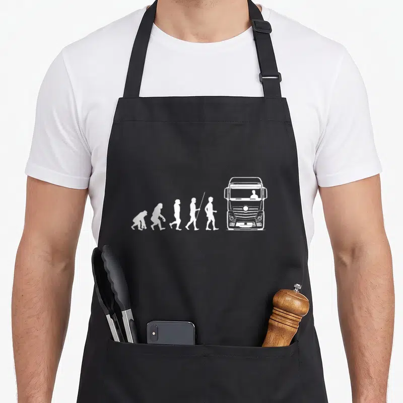 Tablier de cuisine noir avec une illustration blanche montrant l'évolution de l'homme jusqu'à un gros camion routier moderne.