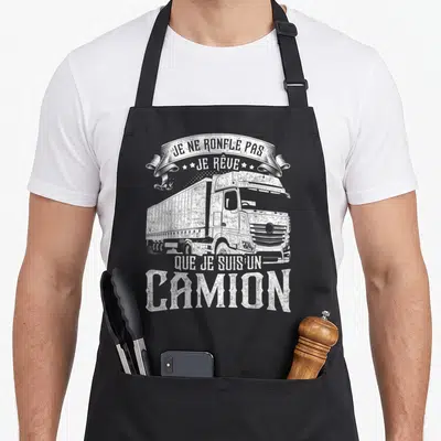 Tablier de cuisine noir avec illustration blanche d'un gros camion et le texte Je ne ronfle pas je rêve que je suis un camion.