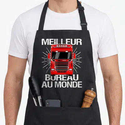 Tablier de cuisine noir avec illustration frontale d'un camion rouge et texte Meilleur bureau au monde en blanc.