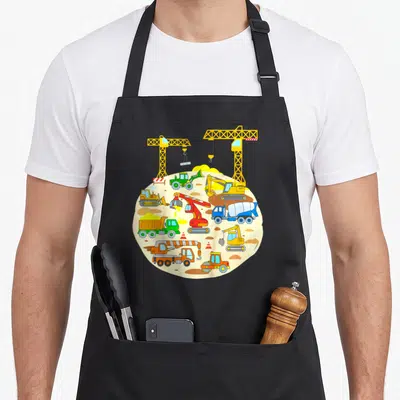 Tablier de cuisine noir avec illustration circulaire de pelleteuse, bulldozer, grues et camions de chantier colorés.