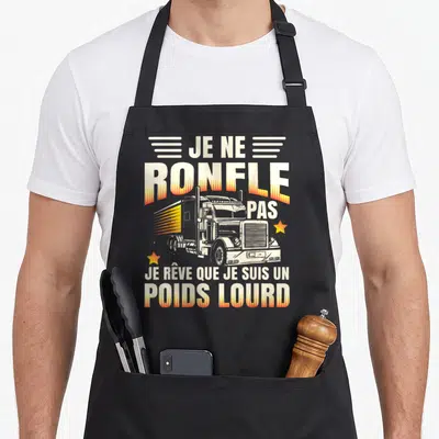 Tablier de cuisine noir avec illustration de truck américain et texte blanc souligné d'effets orange en forme de flammes.