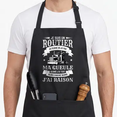 Tablier de cuisine noir avec illustration de semi-remorque et texte blanc humoristique sur fond uni.