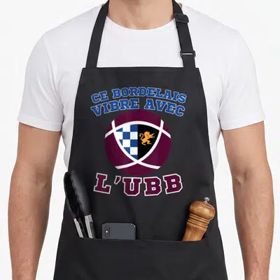 Tablier de cuisine noir avec logo ballon de rugby et texte Ce Bordelais vibre avec L'UBB en bleu et bordeaux.