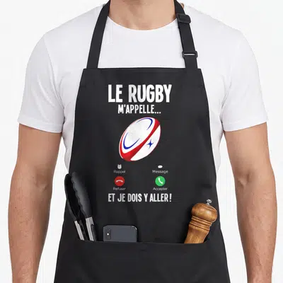 Tablier de cuisine noir avec illustration de ballon de rugby et texte Le Rugby m'appelle et je dois y aller.