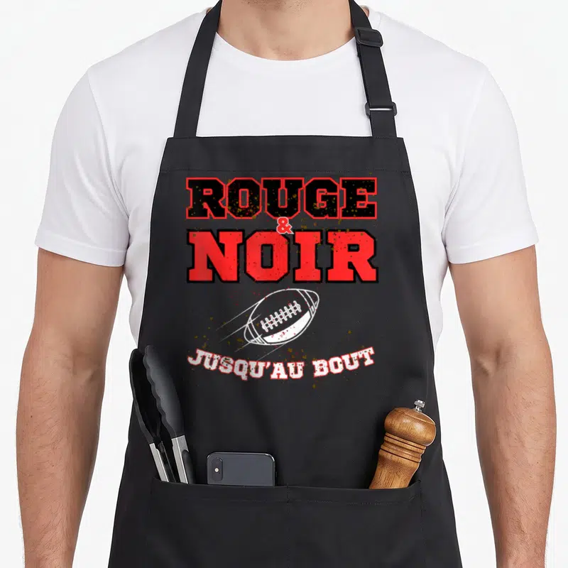 Tablier de cuisine noir avec inscription Rouge et Noir jusqu'au bout et ballon de rugby blanc stylisé.