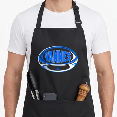 Tablier de cuisine noir avec un logo ovale bleu blanc affichant le mot Vannes et une croix bretonne stylisée.