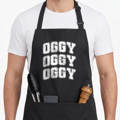 Tablier de cuisine noir avec trois lignes du mot Oggy en grosses lettres blanches effet vieilli.