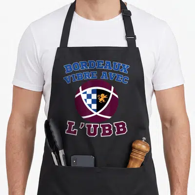 Tablier de cuisine noir avec un ballon de rugby bordeaux et blanc portant le blason de l'Union Bordeleine.