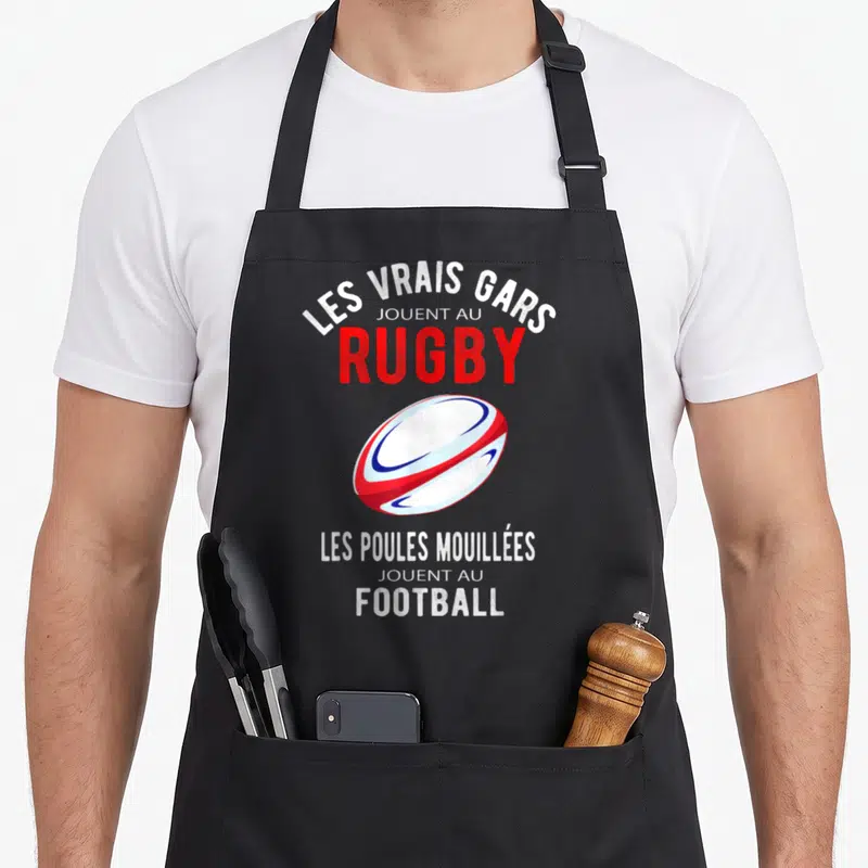 Tablier de cuisine noir avec illustration de ballon de rugby et texte humoristique Les Vrais Gars Jouent au Rugby Football