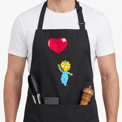 Tablier de cuisine noir avec Maggie des Simpson tenant un grand ballon rouge en forme de cœur.