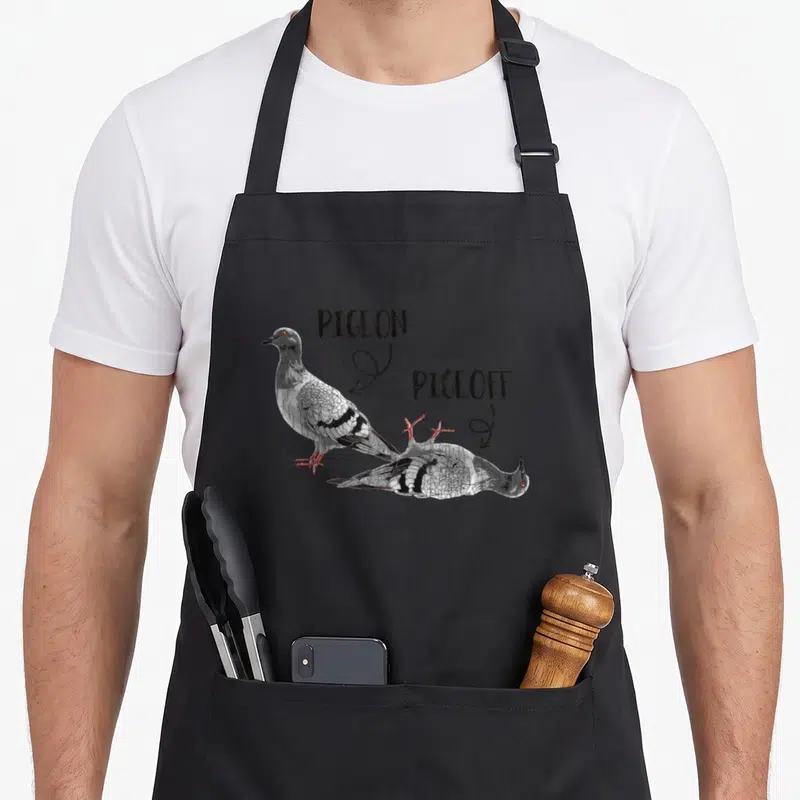 Tablier de cuisine noir avec illustration d'un pigeon et d'un pigeon pique-assis accompagnés des mots Pigeon et Pigeoff.