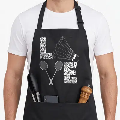 Tablier de cuisine noir avec motif blanc représentant des raquettes croisées, un volant et les lettres LVE stylisées.