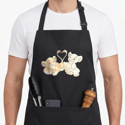 Tablier de cuisine noir avec deux lionceaux aux queues formant un cœur en dessin aquarellé.