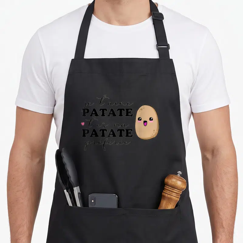 Tablier de cuisine noir avec inscription Je T'aime Patate et illustration d'une pomme de terre souriante rose et marron.