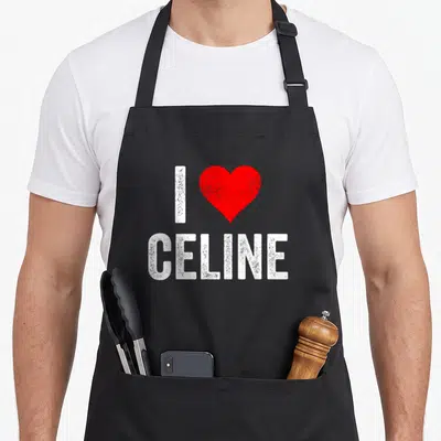Tablier de cuisine noir avec inscription blanche I Love Celine et un cœur rouge vif au centre du design imprimé.