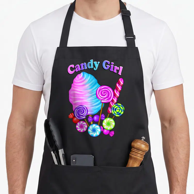 Tablier de cuisine noir avec une grande Sucette en coton rose et bleue, des lollipops colorés et le texte Candy Girl en haut.