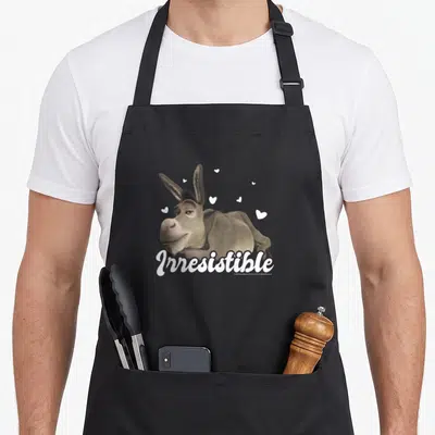 Tablier de cuisine noir avec illustration du Donkey et le texte Irresistible entouré de petits cœurs blancs.