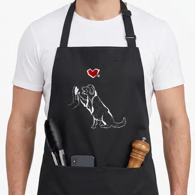 Tablier de cuisine noir avec illustration blanche d'un chien faisant un high five sous un cœur rouge vif.