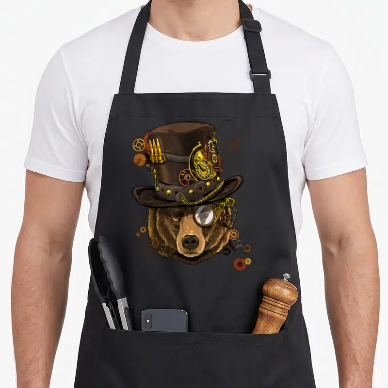 Tablier de cuisine noir avec un grizzly steampunk chapeau haut de forme et monocle.