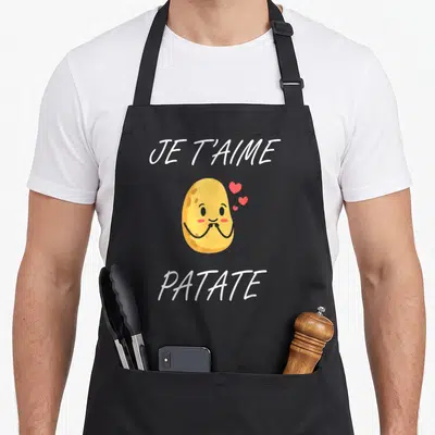 Tablier de cuisine noir avec une illustration de patate souriante et le texte Je t'aime patate en blanc.
