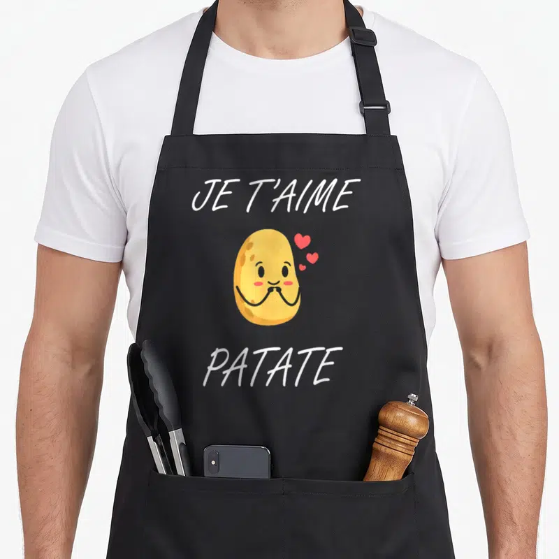 Tablier de cuisine noir avec une illustration de patate souriante et le texte Je t'aime patate en blanc.