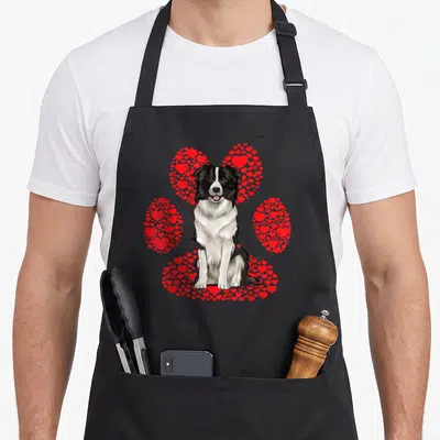 Tablier de cuisine noir avec illustration d'un Border Collie et une patte composée de cœurs rouges.