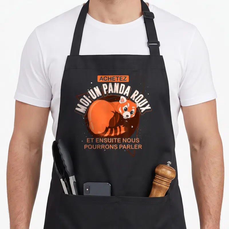 Tablier de cuisine noir avec illustration d'un panda roux et texte humoristique en orange et blanc.