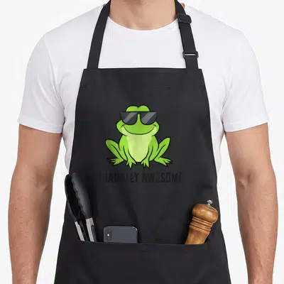 Tablier de cuisine noir avec un crapaud vert souriant portant des lunettes de soleil et le texte Toadally Super.