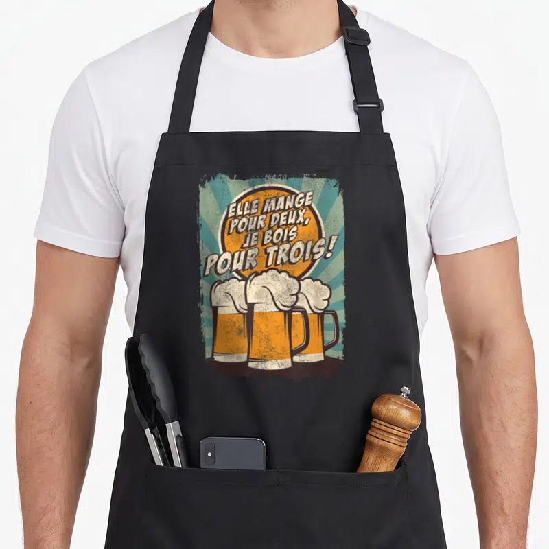 Tablier de cuisine noir avec illustration vintage de trois bières et texte humoristique en lettres blanches et oranges.