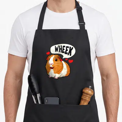 Tablier de cuisine noir avec illustration colorée d'un cochon d'Inde et bulle de dialogue Wheek