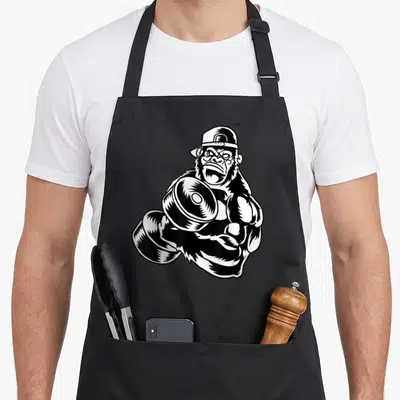 Tablier de cuisine noir avec illustration d'un gorilla gym musclé portant une casquette à l'envers.