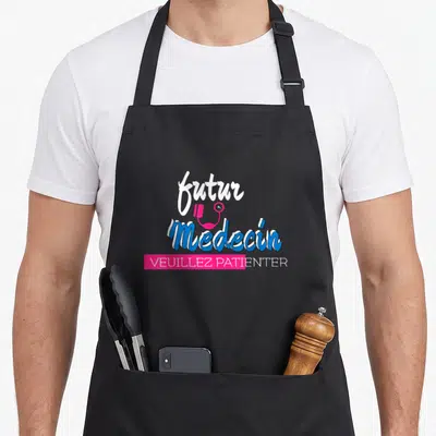 Tablier de cuisine noir avec inscription futur médecin et Veuillez patienter sur fond rose