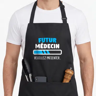 Tablier de cuisine noir avec texte Futur médecin et barre de chargement bleue.