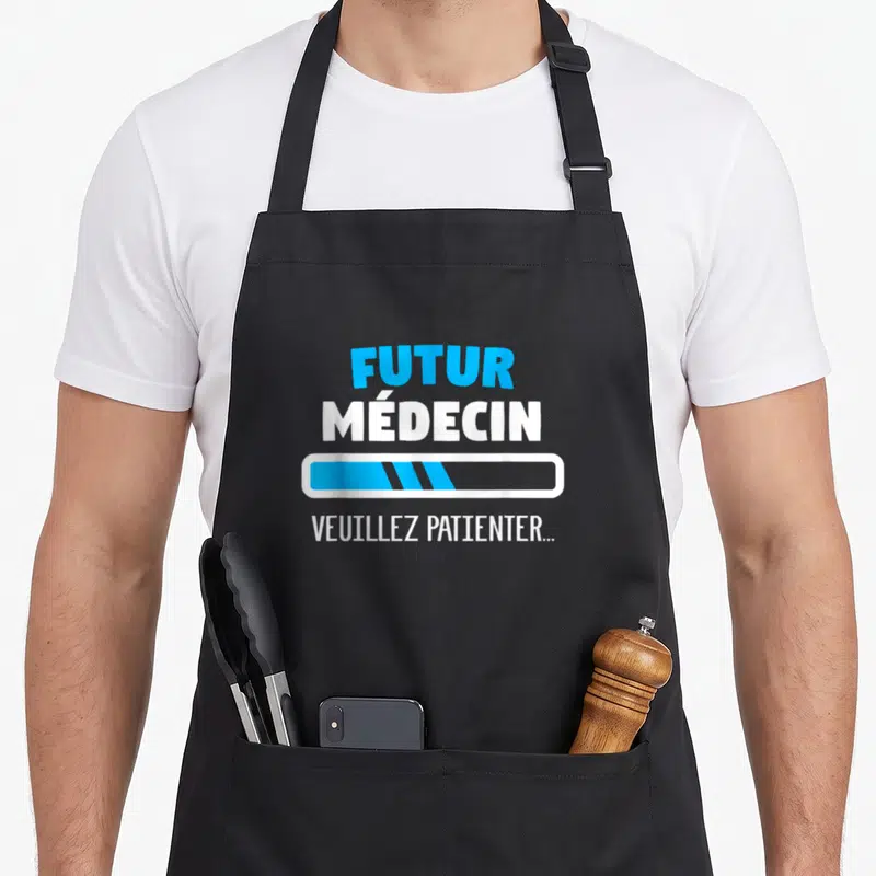 Tablier de cuisine noir avec texte Futur médecin et barre de chargement bleue.