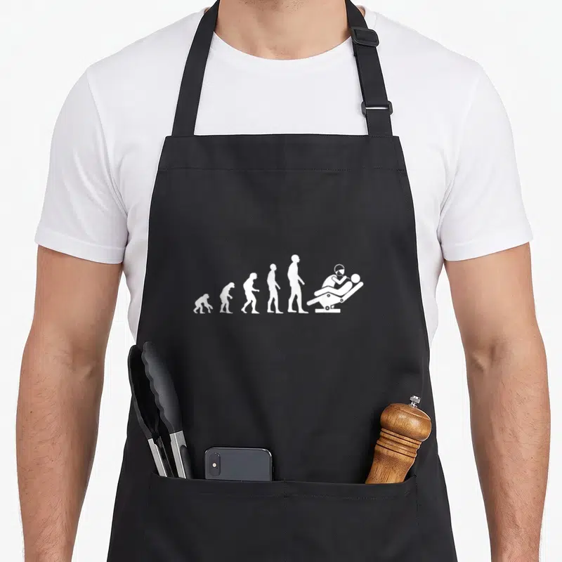 Tablier de cuisine noir avec silhouette blanche représentant l'évolution humaine vers un dentiste au fauteuil.